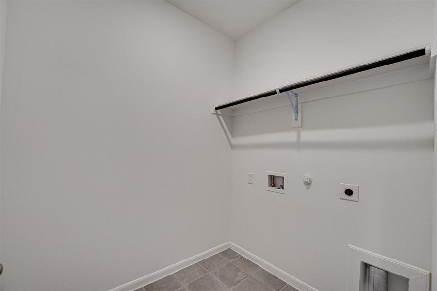 Laundry area featuring hookup for a gas dryer, hookup for an electric dryer, washer hookup, and tile patterned flooring