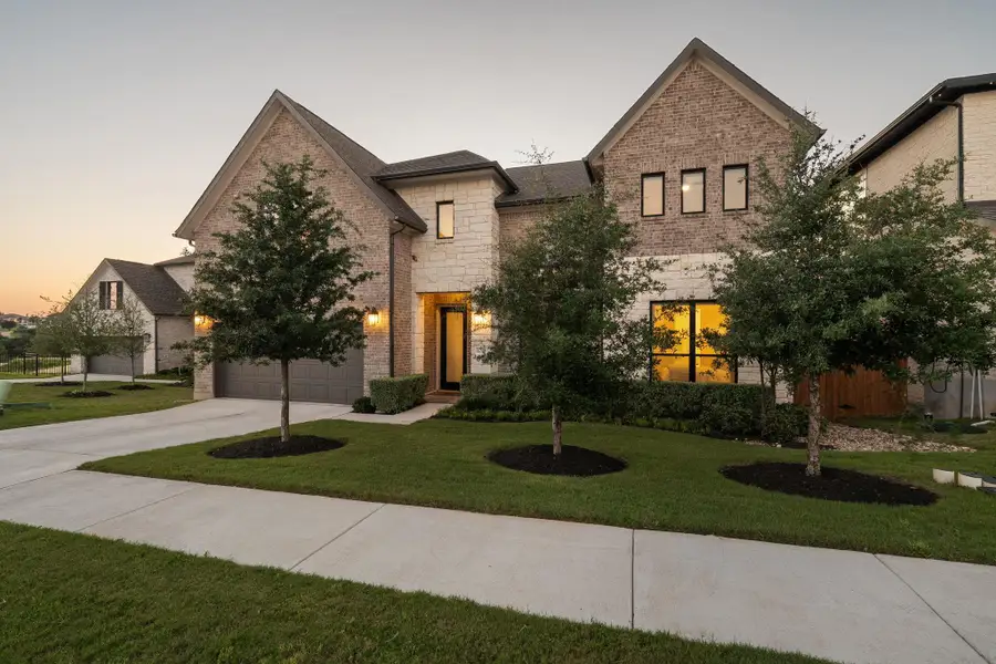 Contemporary exterior featuring a combination of brick and light-toned stone Contemporary exterior featuring a combination of brick and light-toned stone