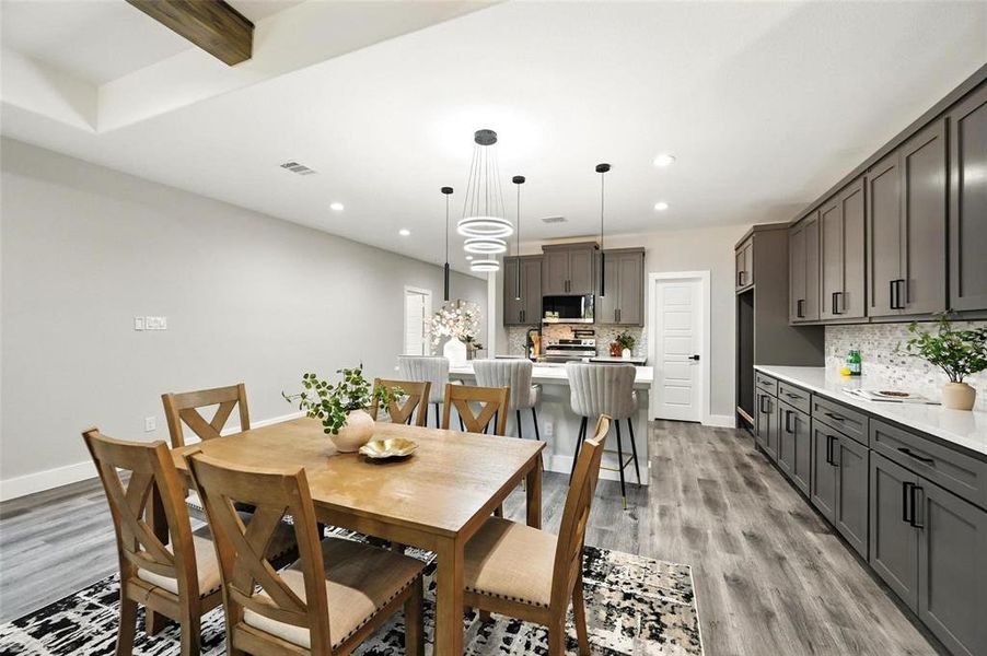 Dining area with light wood-style flooring and recessed lighting Dining area with light wood-style flooring and recessed lighting