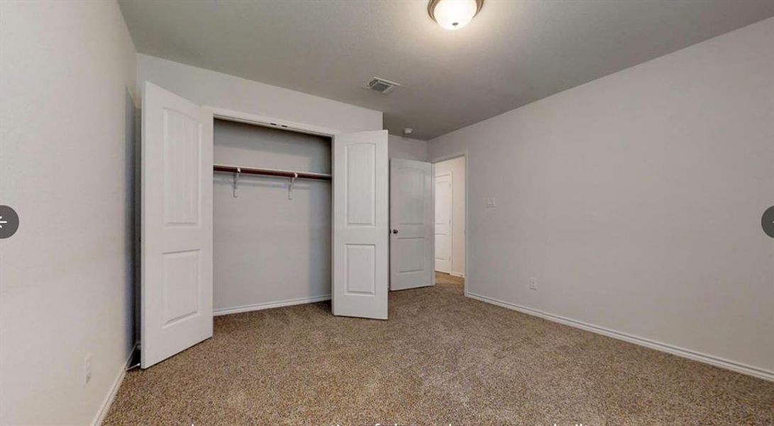 Unfurnished bedroom with carpet flooring, baseboards, and a closet