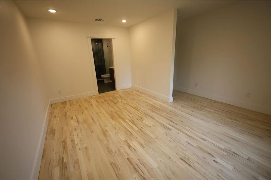 Unfurnished room with light wood flooring and recessed lighting