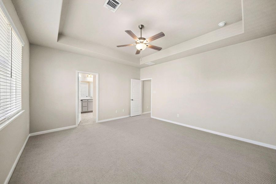 This generous primary bedroom offers an expansive layout, providing ample space for a king-sized bed and additional furniture.