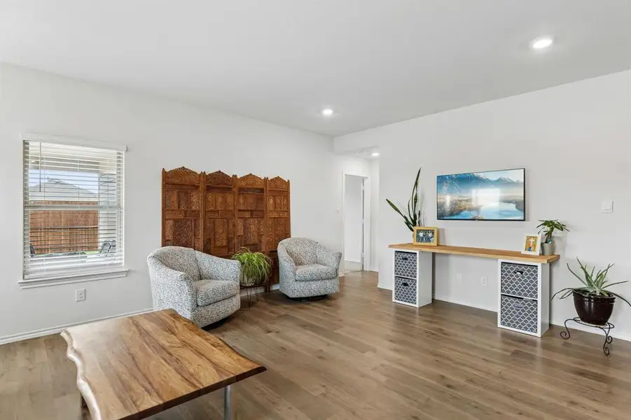 Living area with wood finished floors and recessed lighting Living area with wood finished floors and recessed lighting