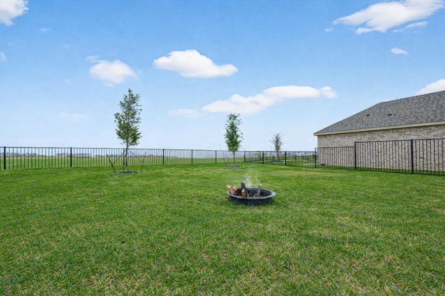 Expansive backyard with wrought-iron fencing and open views, perfect for enjoying wide-open skies.