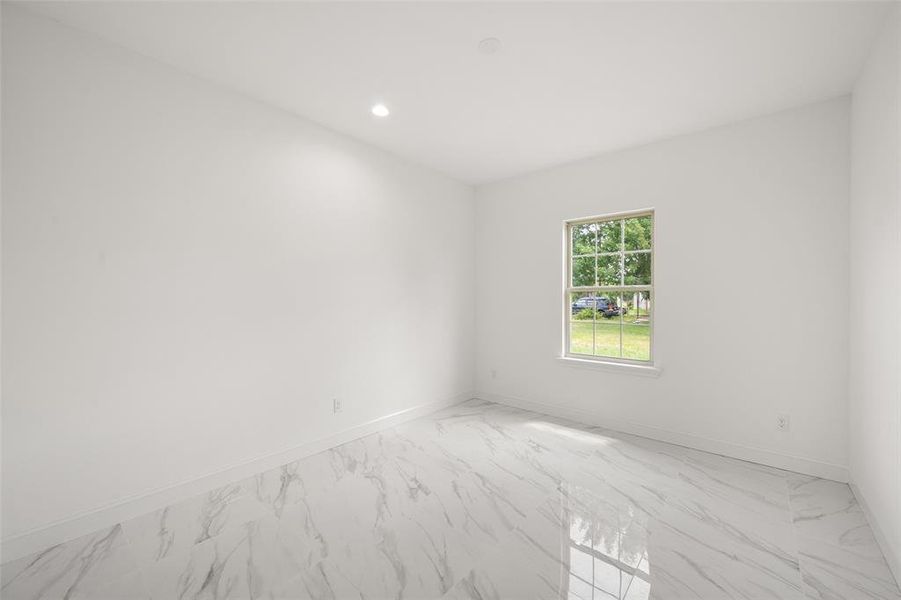 Unfurnished room with light marble finish floors and recessed lighting Unfurnished room with light marble finish floors and recessed lighting