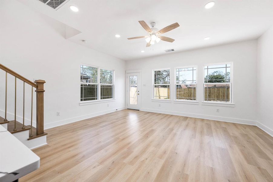 Bright living area with plenty of natural light and wood-style flooring.