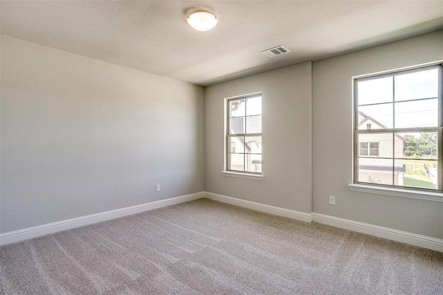 Spare room featuring carpet and baseboards Spare room featuring carpet and baseboards