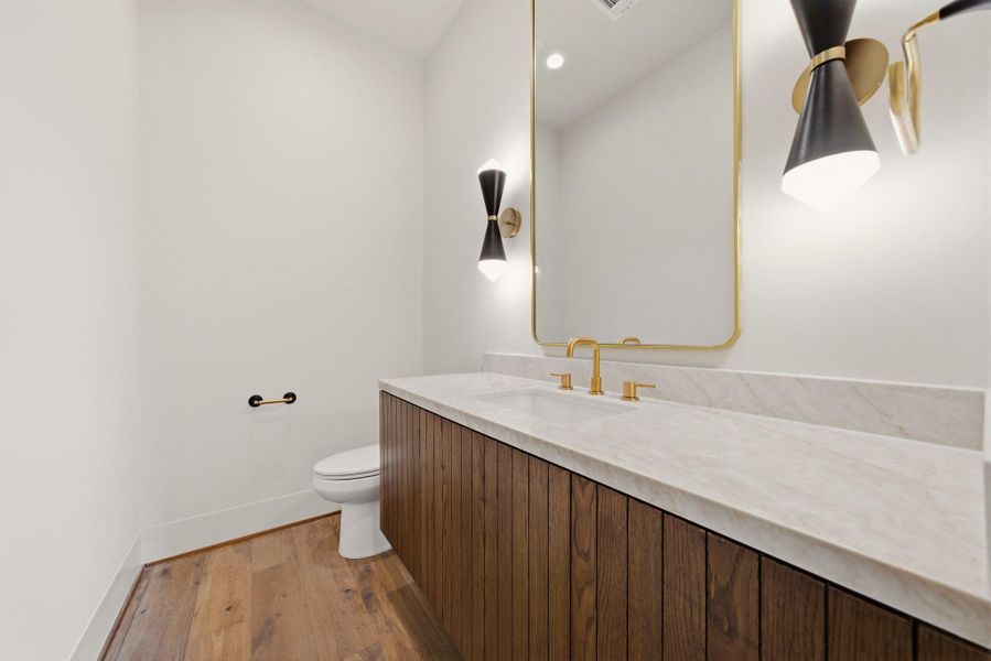 First floor half bathroom for guests with designer finishes.