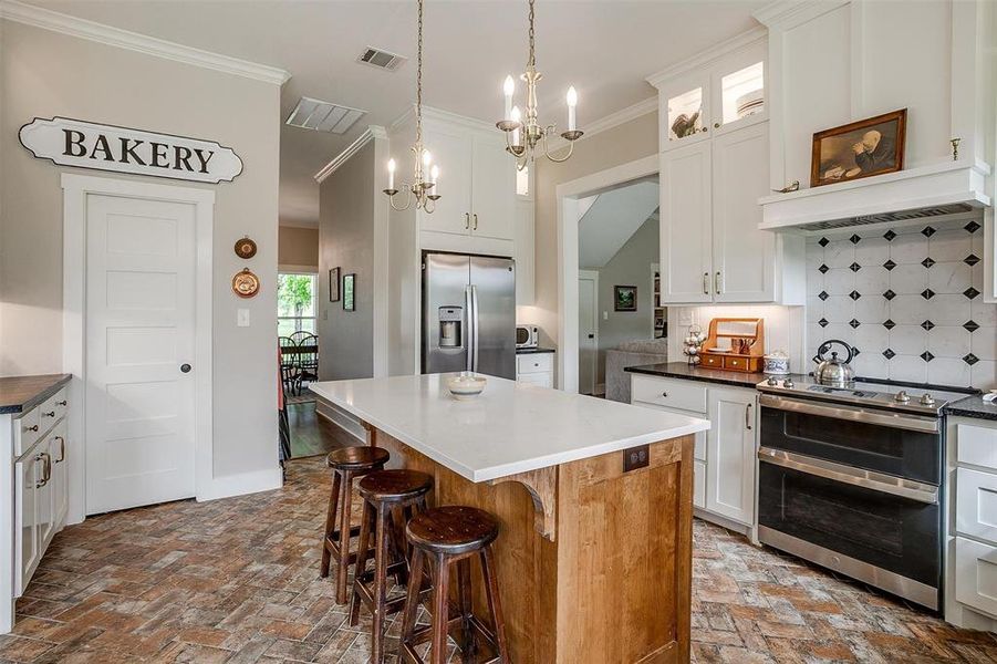 Kitchen with island & stainless appliances. Kitchen with island & stainless appliances.