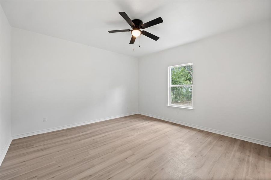 Unfurnished room with light wood-style floors and ceiling fan