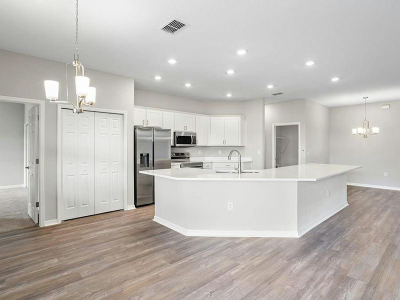 Ample dining space is available thanks to the island, sunny cafe, and formal dining room - Willow II by Highland Homes