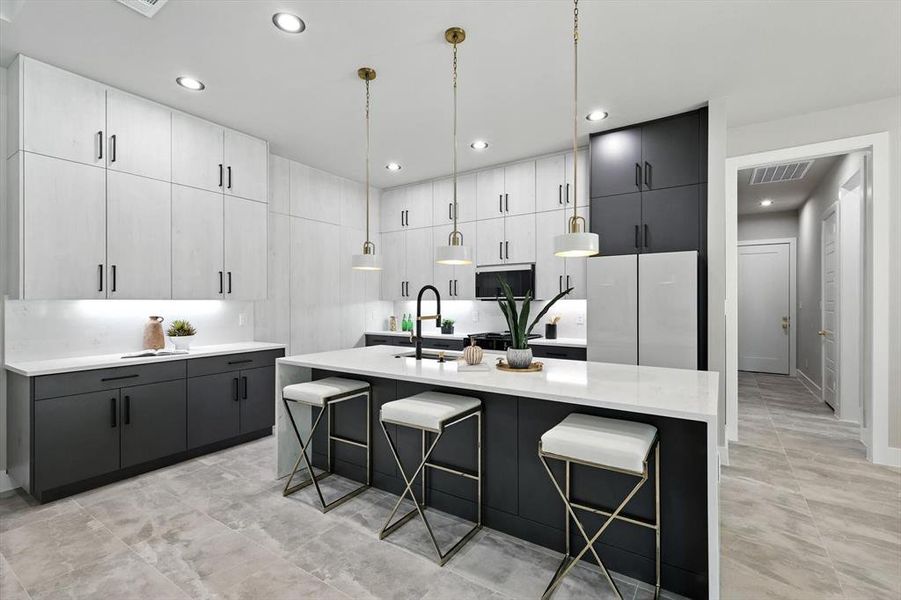Kitchen with decorative light fixtures, modern cabinets, an island with sink, a breakfast bar area, and white cabinetry