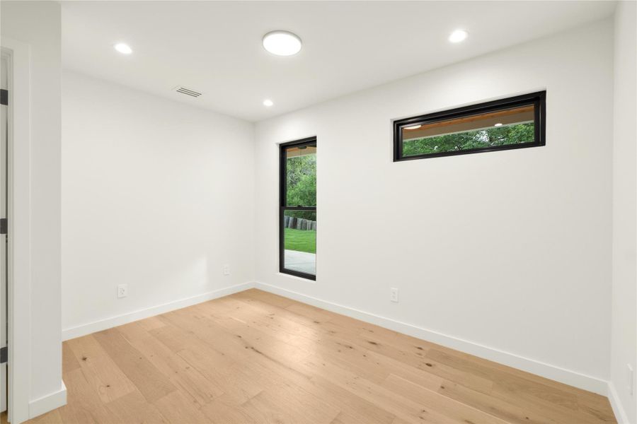 Unfurnished room with light wood-style flooring, baseboards, and recessed lighting