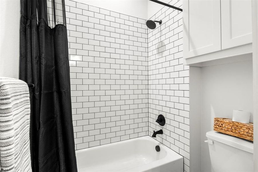 Bathroom featuring shower / tub combo with curtain