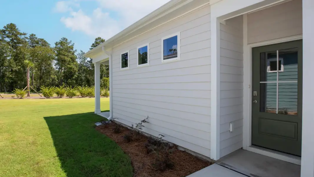 Exterior details and patio area of a home in The Retreat at Indigo Preserve Townhomes, Leland (Image 16).