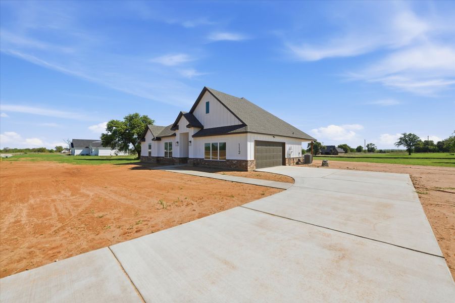 Front exterior of a new home in Zion Valley, Poolville, TX, highlighting curb appeal (Image 18). Front exterior of a new home in Zion Valley, Poolville, TX, highlighting curb appeal (Image 18).