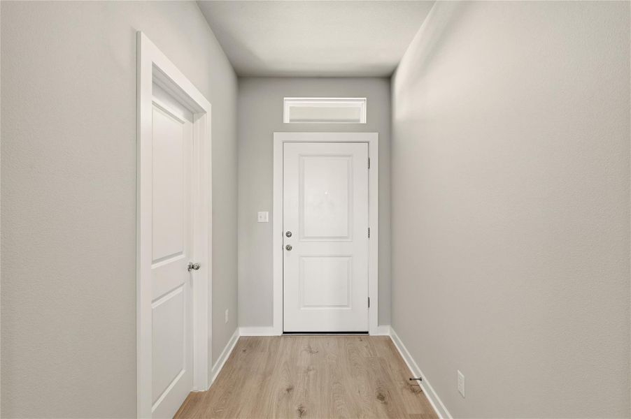 Entryway featuring wood finished floors and baseboards
