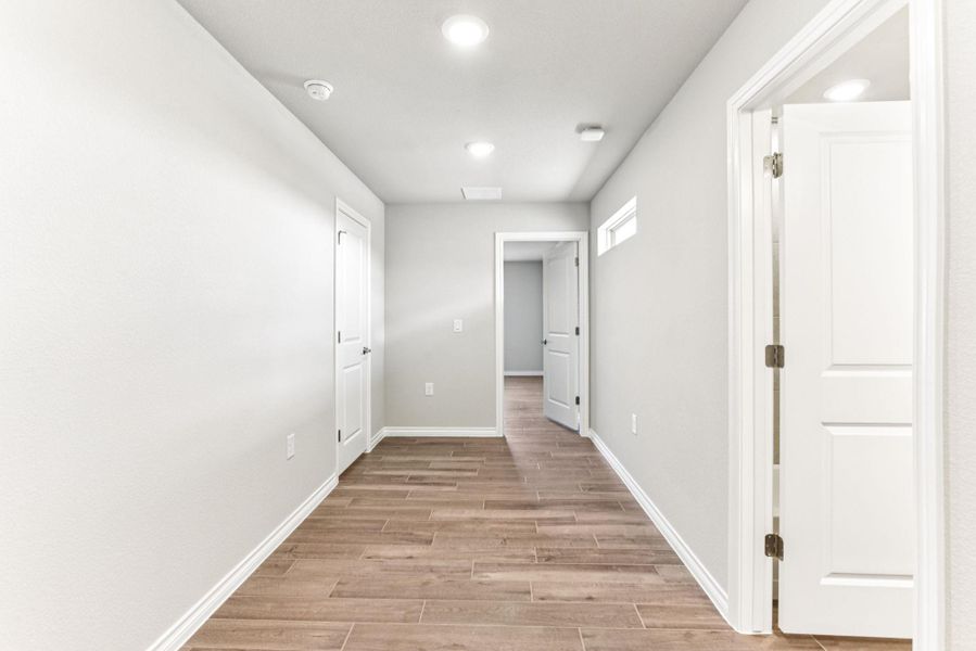 Hallway featuring wood tiled floors and recessed lighting Hallway featuring wood tiled floors and recessed lighting