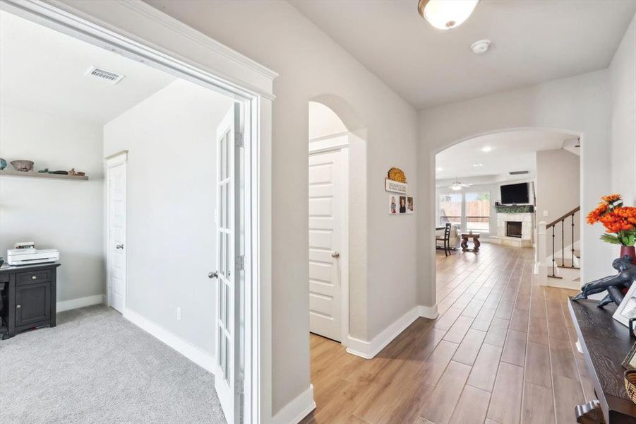 Hallway with light hardwood / wood-style floors