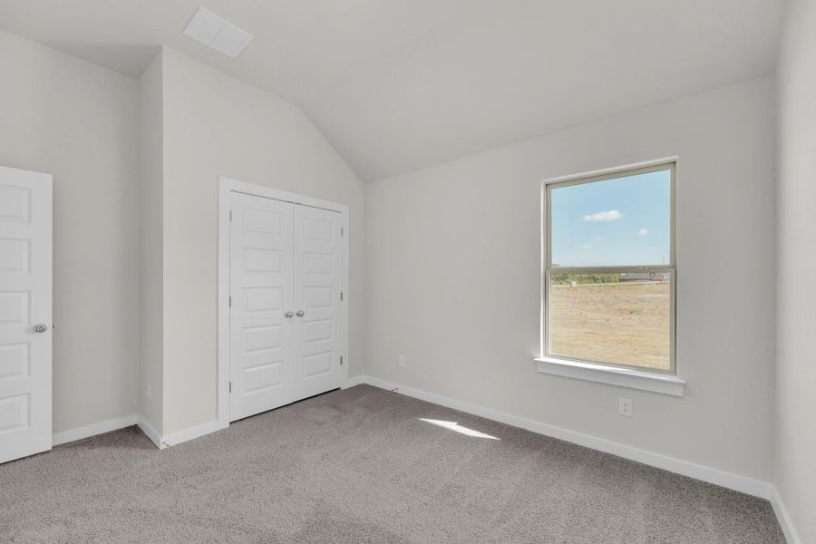 Bedroom in the Evelyn Pecos model home in Austin TX by Trophy Signature Homes