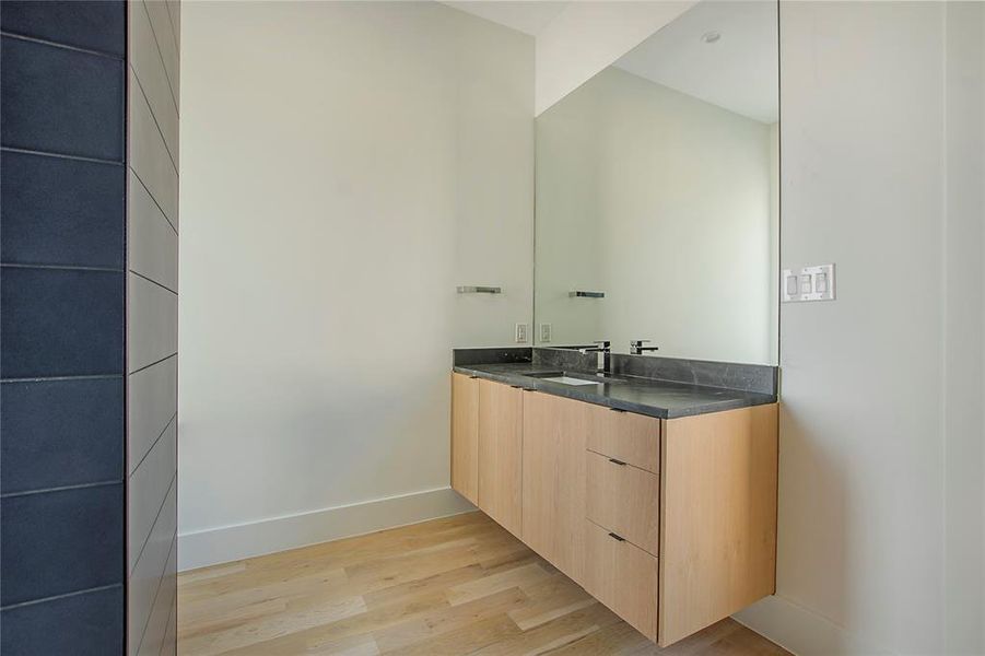 Bathroom with hardwood / wood-style flooring and vanity