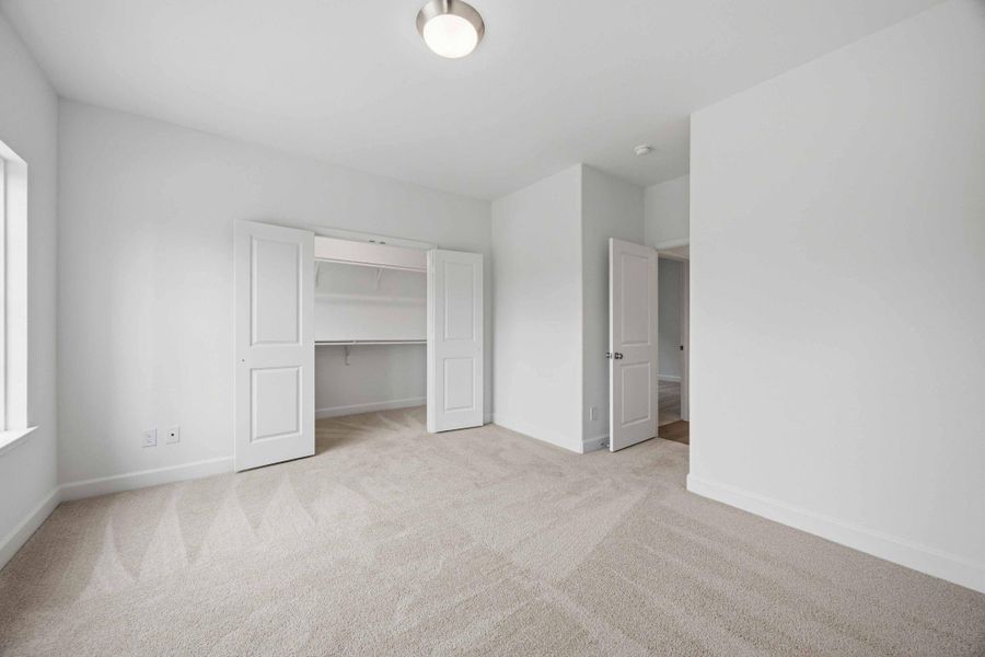 Room to Grow. The spacious secondary bedroom features a walk-in closet and plenty of natural light.