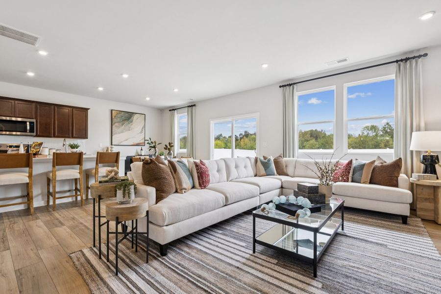 A large living room with a large window. A large living room with a large window.