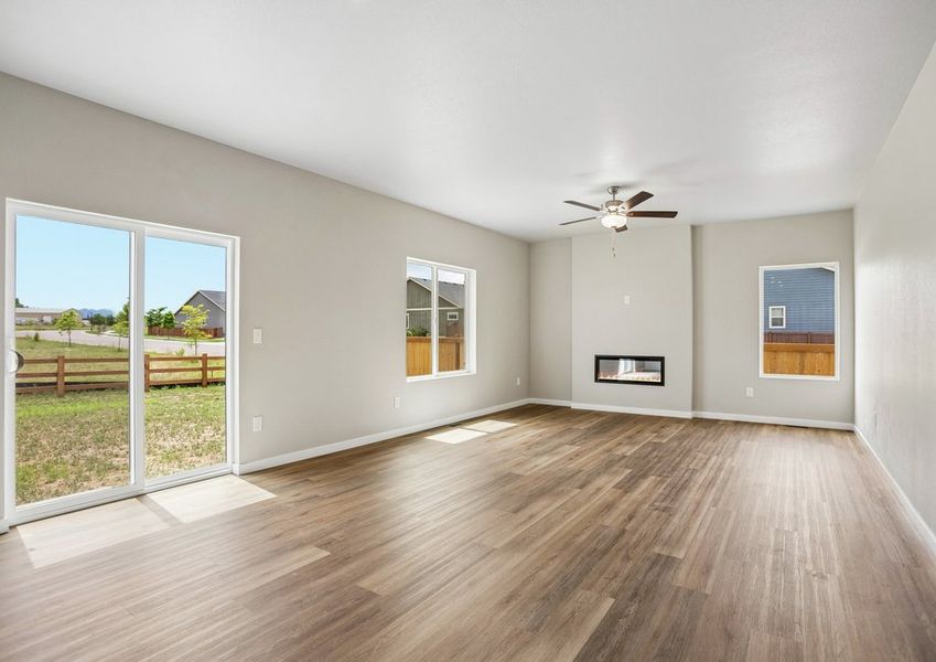 The family room is spacious with a ceiling fan and an electric fireplace.