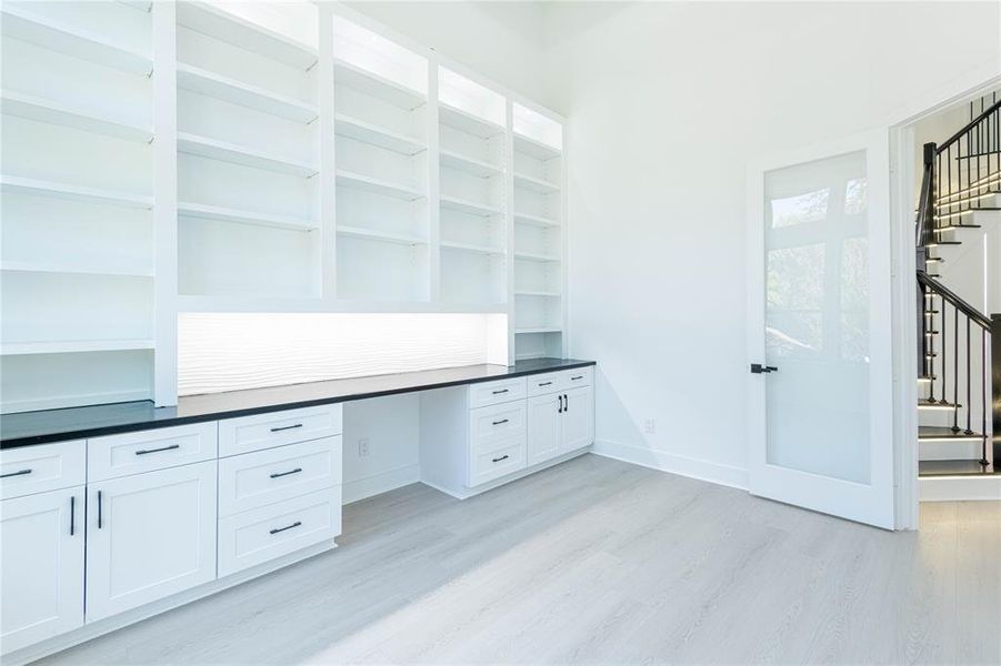 Office with shelves and high ceilings.