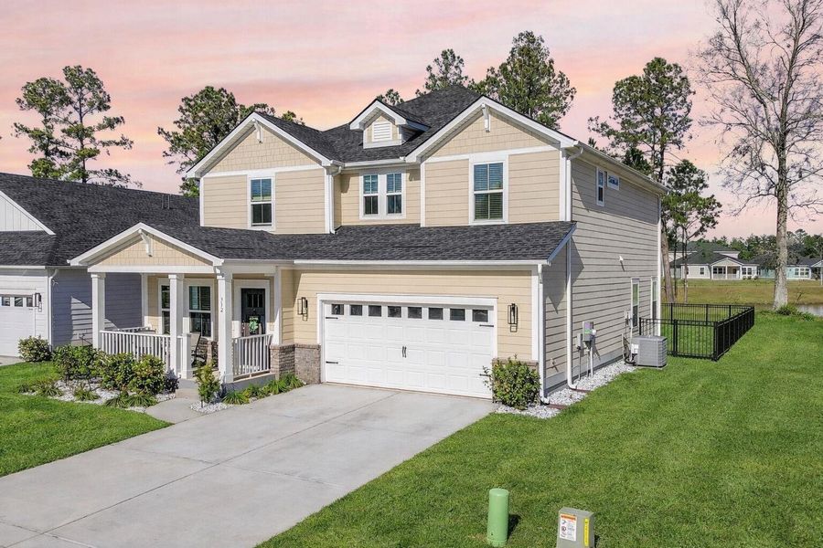 Front exterior of a new home in The Coves at Lakes of Cane Bay, Summerville, SC, highlighting curb appeal (Image 2). Front exterior of a new home in The Coves at Lakes of Cane Bay, Summerville, SC, highlighting curb appeal (Image 2).