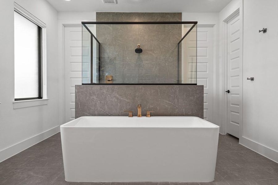 Luxurious bathroom retreat showcasing a freestanding soaking tub and an open-concept walk-in shower. Luxurious bathroom retreat showcasing a freestanding soaking tub and an open-concept walk-in shower.