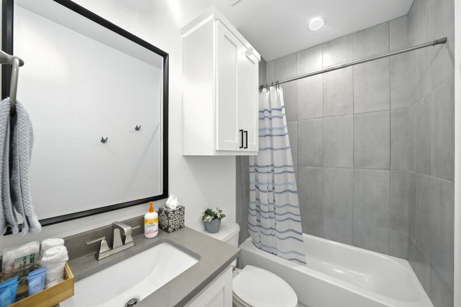 Full bathroom with vanity and shower/tub combo Full bathroom with vanity and shower/tub combo