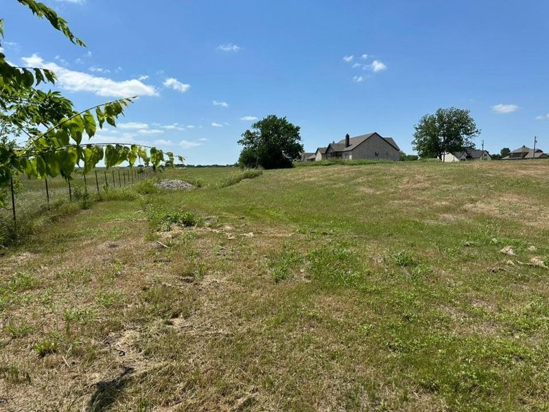 Expansive green space featuring a gentle slope