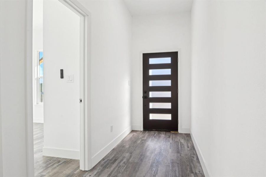 Entryway with wood finished floors and baseboards