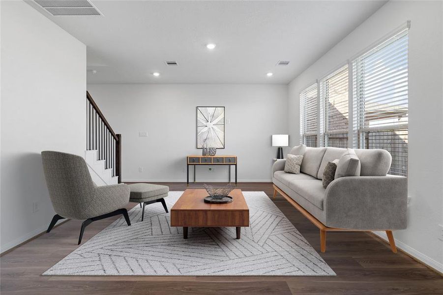 Gather the family and guests together in your lovely family room! Featuring high ceilings, recessed lighting, custom paint, gorgeous floors and large windows with privacy blinds that provide plenty of natural lighting throughout the day.