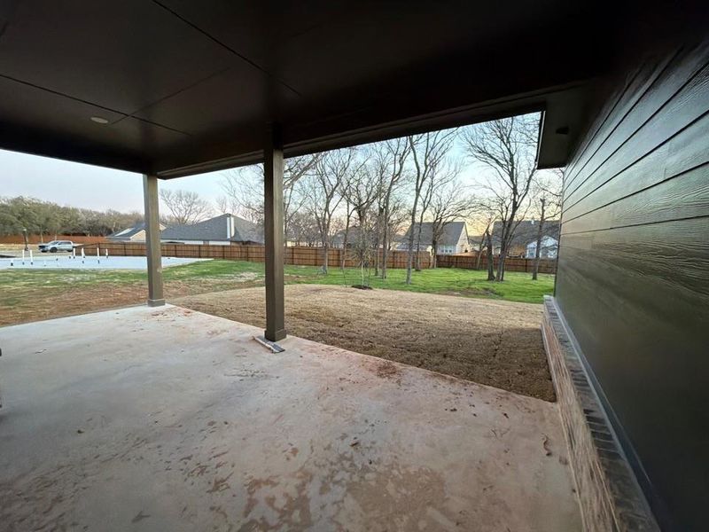 Fenced backyard featuring a patio