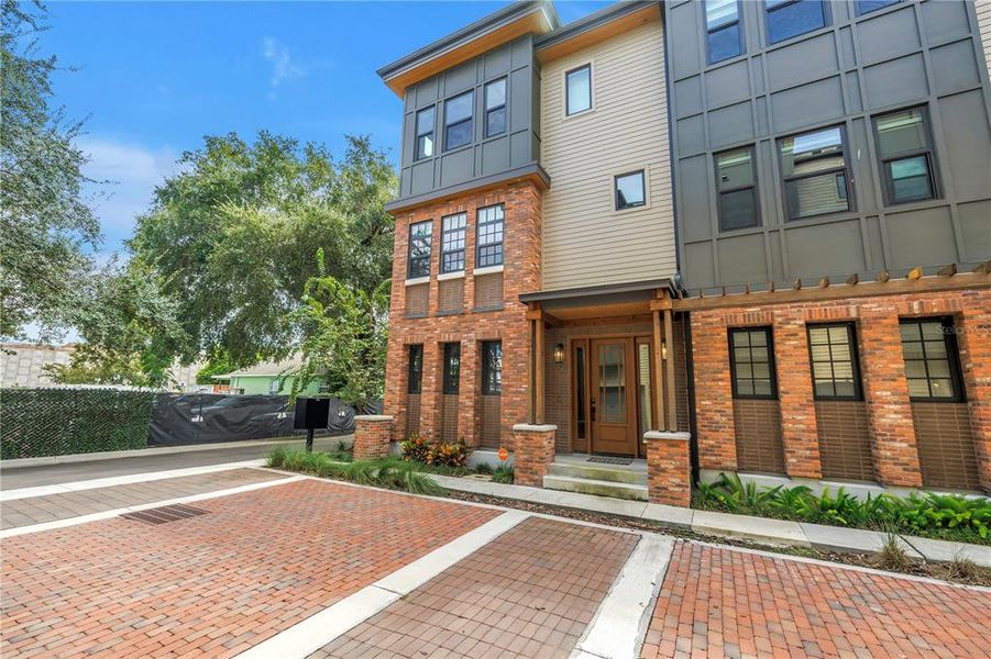 Front exterior of a new home in East Oak Townhomes, Tampa, FL, highlighting curb appeal (Image 26).