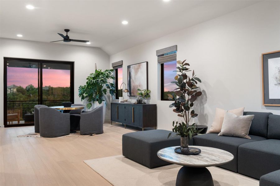 A refined living area boasts light wood flooring and panoramic sunset views through generous windows. A refined living area boasts light wood flooring and panoramic sunset views through generous windows.