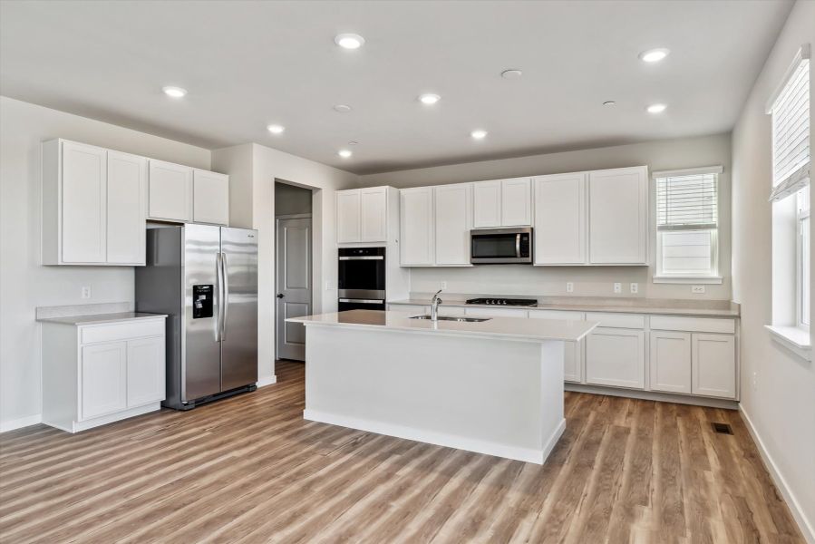 A kitchen with white cabinets.