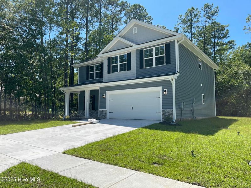 Front exterior of a new home in Mill Creek Cove, Bolivia, NC, highlighting curb appeal (Image 13).