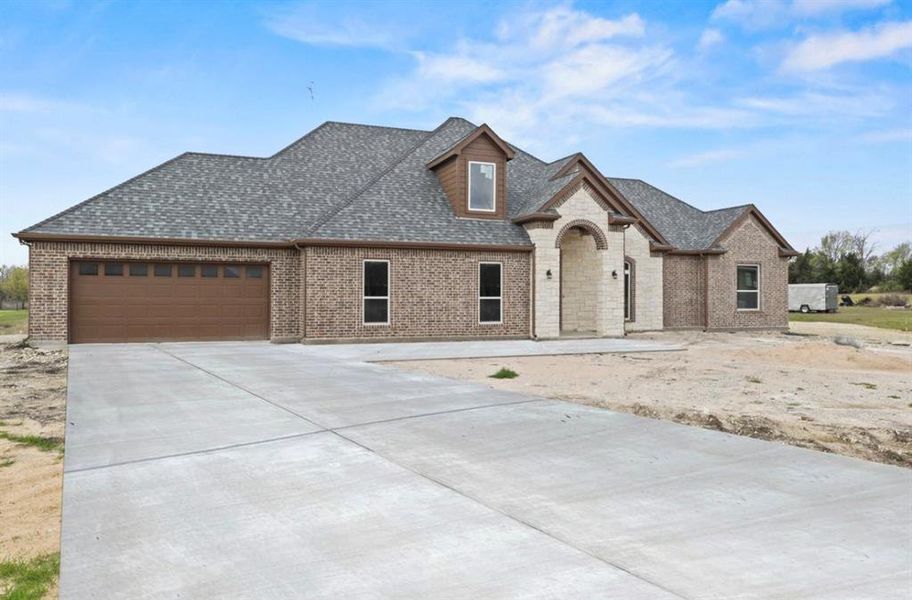 French provincial home with a garage