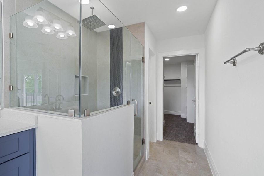 Wait till you step in the massive seamless walk-in shower! Rain shower for your relaxing shower!  Custom tile surroundings, mud bottom, no cheap plastic bottom in this Builders Home! Never run out of hot water so, just relax and feel the rain coming down on you with all the hot water you want!