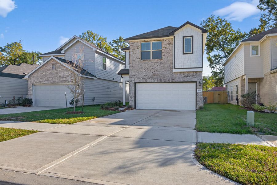 Front exterior of a new home in Woodland Lakes, Huffman, TX, highlighting curb appeal (Image 24). Front exterior of a new home in Woodland Lakes, Huffman, TX, highlighting curb appeal (Image 24).