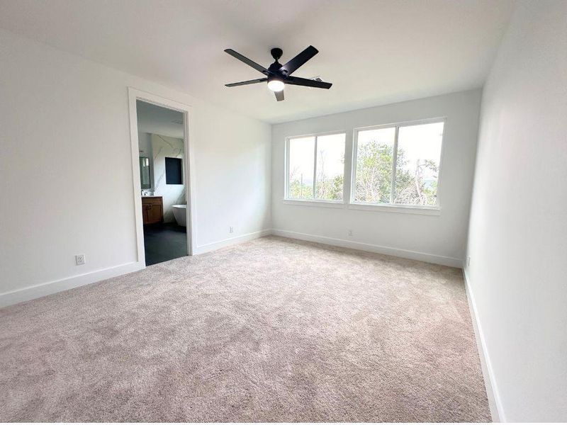 Well-lit sleeping quarters with plush carpeting and expansive windows offer serene views. Well-lit sleeping quarters with plush carpeting and expansive windows offer serene views.