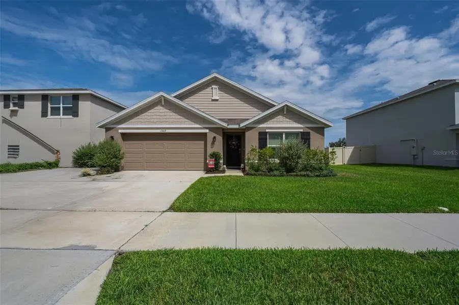 Front exterior of a new home in Pine Creek, Spring Hill, FL, highlighting curb appeal (Image 2). Front exterior of a new home in Pine Creek, Spring Hill, FL, highlighting curb appeal (Image 2).