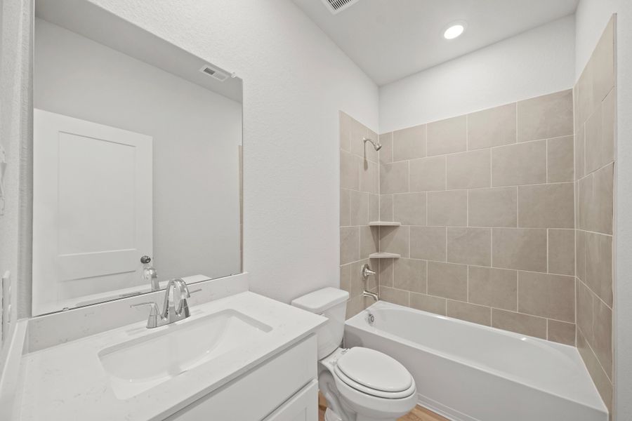 A bathroom with a tub sink and toilet. A bathroom with a tub sink and toilet.