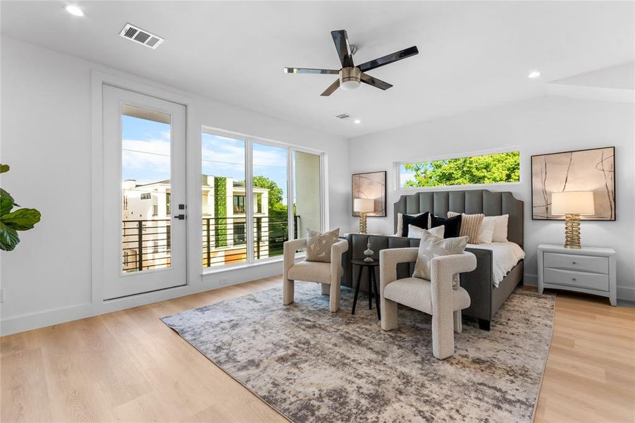 Bedroom featuring light wood-finish flooring and a contemporary ceiling fan Bedroom featuring light wood-finish flooring and a contemporary ceiling fan