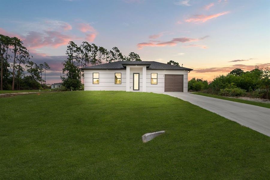 Front exterior of a new home in , Lehigh Acres, FL, highlighting curb appeal (Image 20).