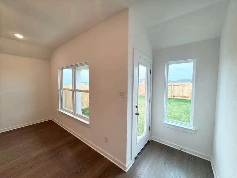 Entryway with vaulted ceiling, dark wood finished floors, and plenty of natural light