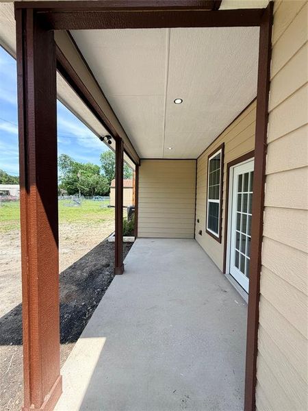 Covered patio featuring concrete flooring and recessed lighting